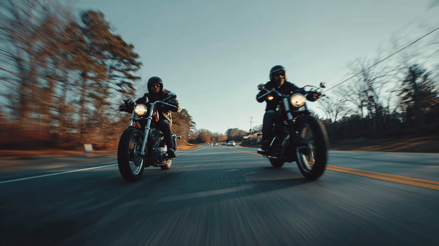 Two motorcycles riding side by side down the road